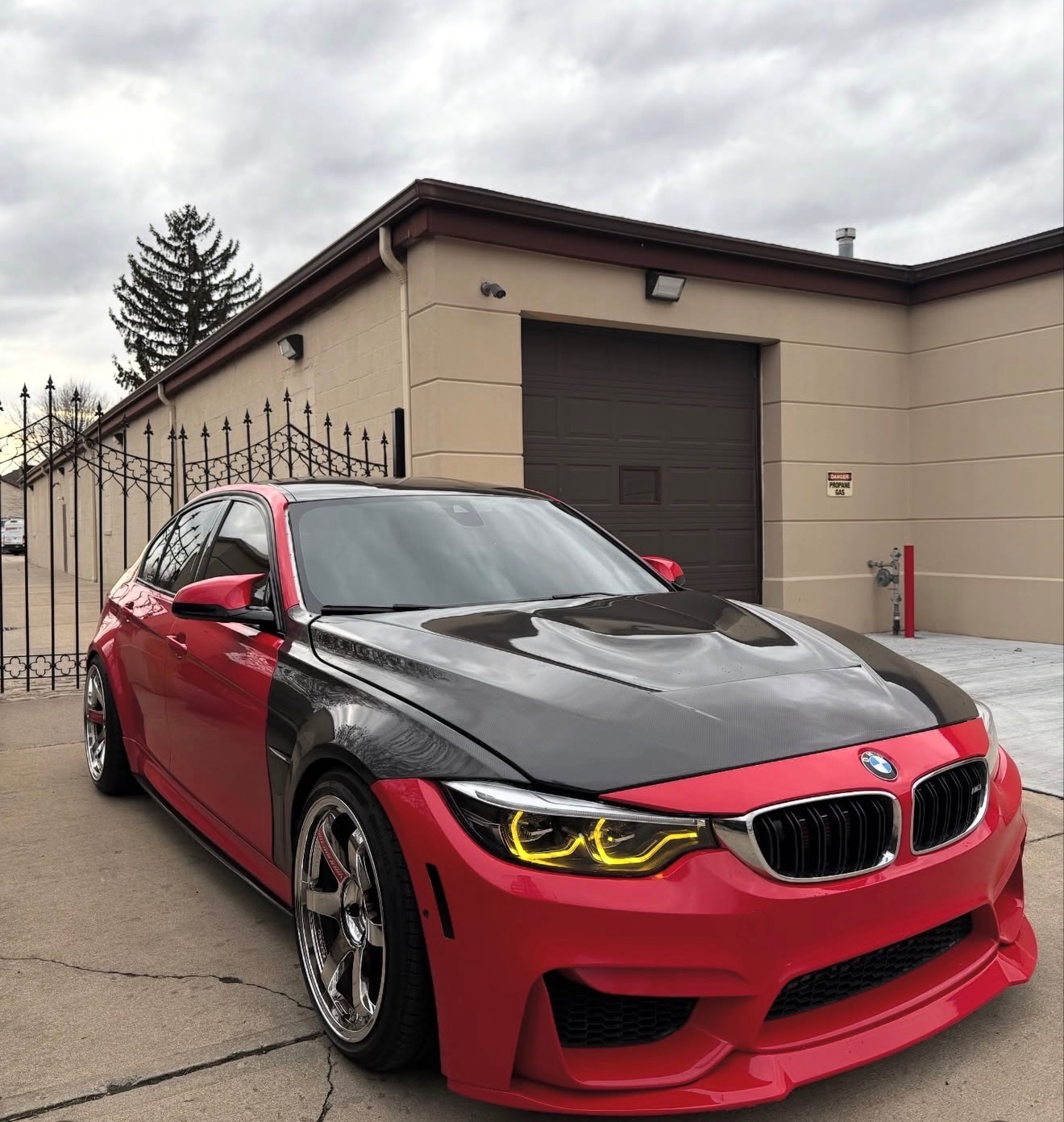 Red BMW M3 with carbon fiber hood and yellow halo headlights