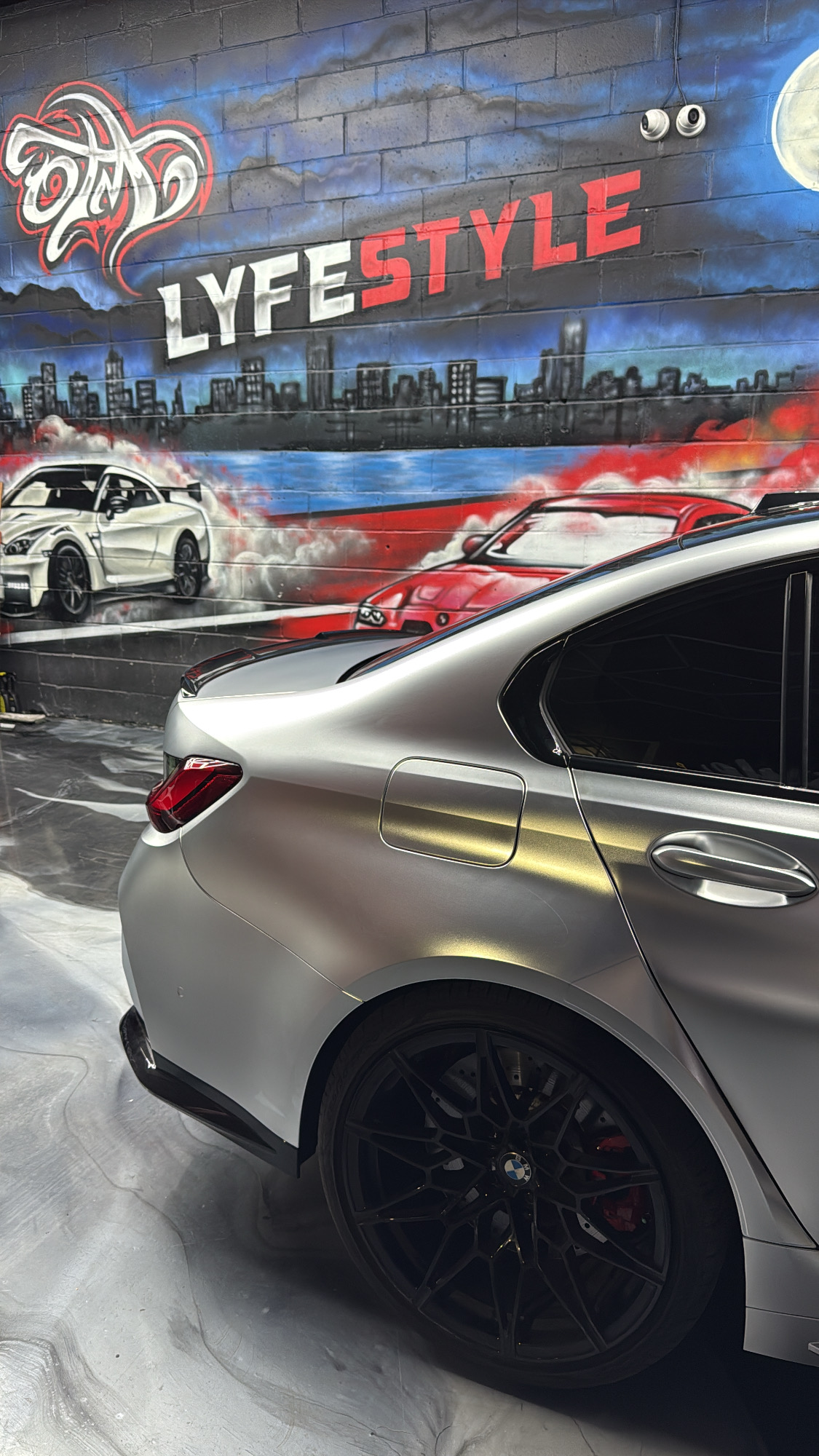 Satin silver BMW M3 inside the Lyfestyle Customz shop