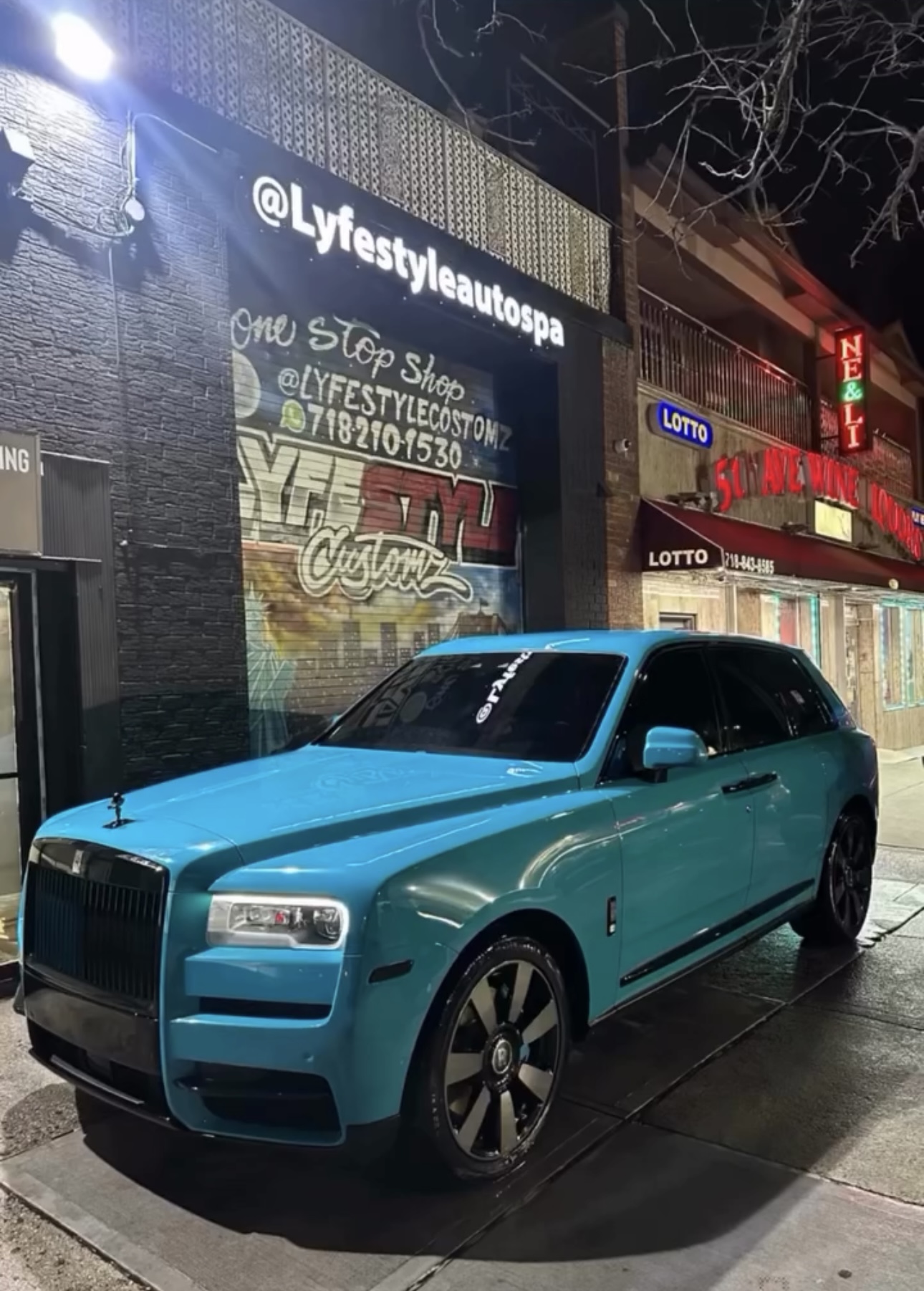 Turquoise Rolls-Royce Cullinan wrap outside the Queens shop